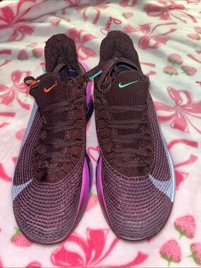Nike Maroon Knit Sneakers with Purple Midsole and Multicolor Swooshes.